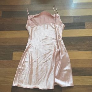Pink silk dress, with writing on the front. Size M